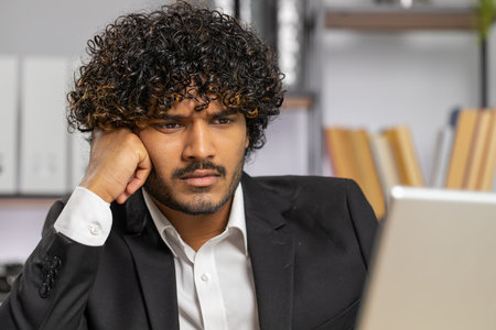 Tired indian businessman feeling worried about financial problem, stress at home office workplace....