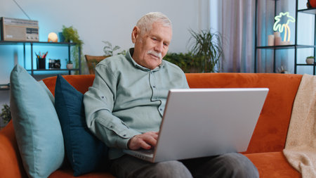 Displeased senior grandfather man use laptop notebook typing browsing working, loses becoming...