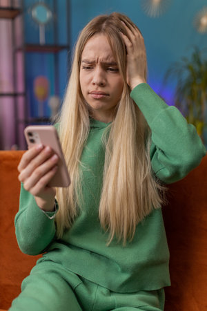 Sad displeased woman use smartphone typing browsing, loses becoming surprised sudden lottery...
