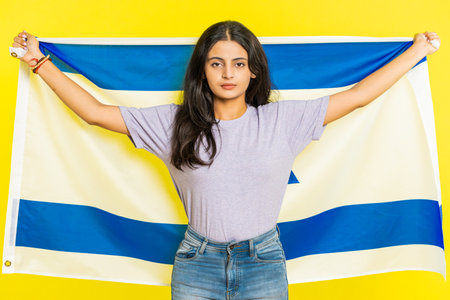 Indian woman holds Israel national flag showing protest against war, hoping for success and win,...