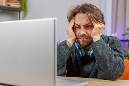 Tired Caucasian man freelancer use laptop, suffering from headache problem tension, migraine, stress...