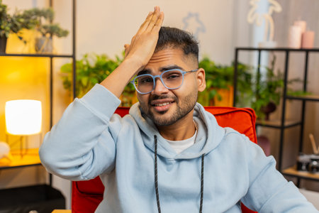 Face palm. Shame on you. Upset Indian man making disrespect gesture, feeling bored, disappointed in...