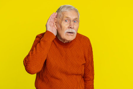 I cant hear you. What. Senior old man trying hear you, looking confused and frowning keeping arm...
