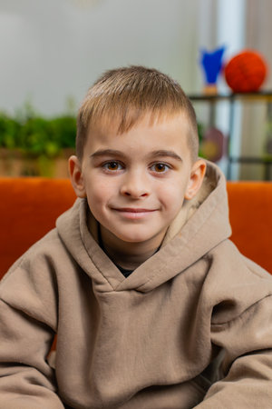 Close-up portrait of happy smiling cheerful Caucasian preteen school boy 8 years old. Young lovely...