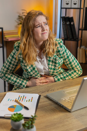 Disappointed freelancer feeling overeating during work process on laptop in home office. Upset...