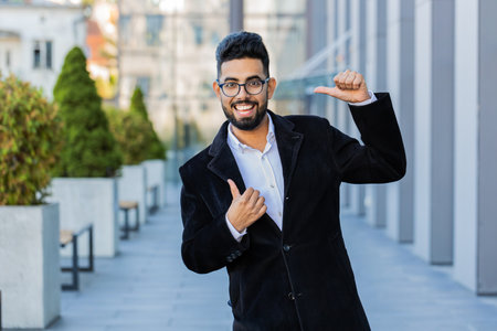 Happy Indian business man celebrating success, winning, career achievement, good news, luck,...