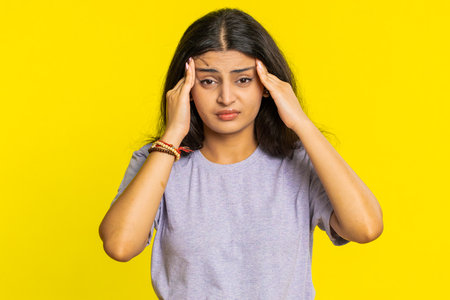 Displeased exhausted Indian Hindu woman girl rubbing temples to cure headache problem, suffering...
