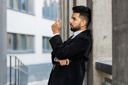 Unhappy sad Indian business man frustrated stress pensive feeling bad after company lost job unemployment problem financial crisis. Arabian Hindu freelancer guy stay at office business center buildingの写真素材