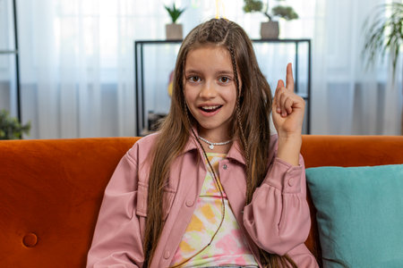 Eureka. Inspired girl pointing finger up having good idea, plan, startup, showing inspiration...