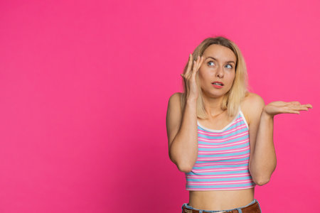 I dont know what to say. Confused Caucasian young woman feeling embarrassed about ambiguous...