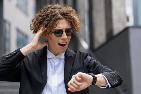 Young Caucasian businessman check time looking at wrist watch shock lateness hurry go faster...