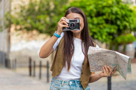 Caucasian young woman tourist traveling on weekends exploring town looking city map, making photo...