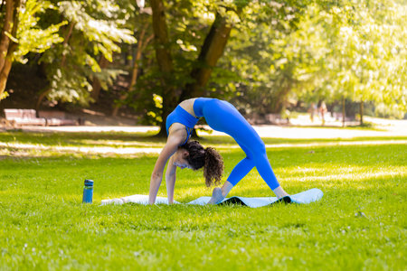 Flexible young woman doing yoga stretching exercises on mat, workout, gymnastic, training strength,...