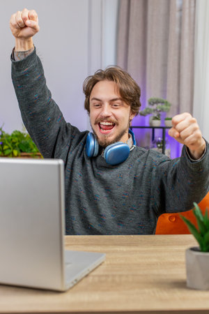 Surprised man using laptop computer, receive mail good news message shocked by sudden victory...