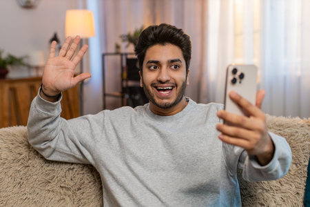 Man making video call with wave happy chat and communication on internet online app and social...