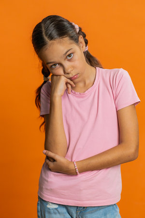Tired bored preteen child girl kid indifferent expression, exhausted of tedious story, not...