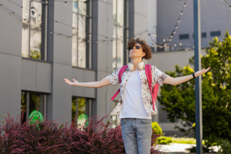 Caucasian young man meditating, breathes deeply with mudra gesture, praying eyes closed, concentrated thoughts, peaceful mind outdoors. Guy taking a break in urban city street.の写真素材
