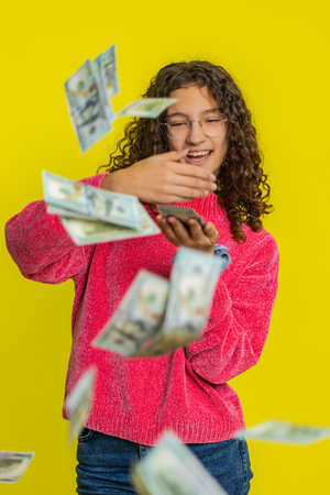 Rich young teenager girl wasting throwing sharing money dollar cash around more tips big profit...