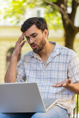 Displeased man using laptop typing browsing working, loses becoming surprised sudden lottery results...