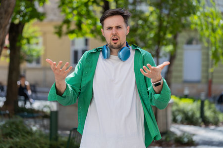 I dont know what to say. Confused young man feeling embarrassed about ambiguous question, having...