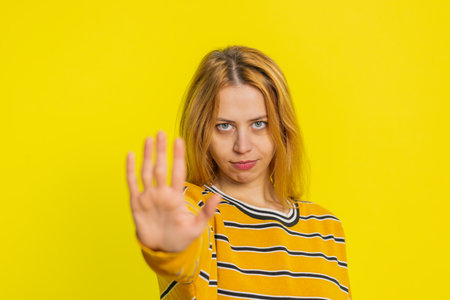 Stop, enough. Young woman say no hold palm folded crossed hands in finish gesture, warning of...