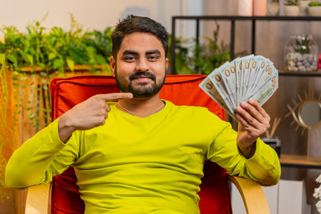Happy rich business Arabian man counting money cheering up with high profits, celebrate lottery game...