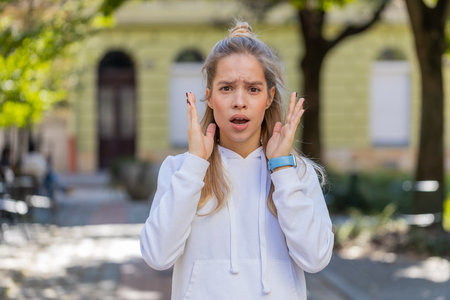 Shocked upset woman reacting to unpleasant awful idea, dissatisfied with bad quality shake head No, dismiss proposition, dont like proposal outdoors. Closeup Caucasian girl tourist on city street.の写真素材