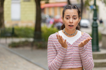 Sad unhappy Caucasian young woman thinks over life concerns, suffers from unfair situation outdoors....