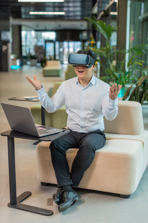 Middle-aged businessman programmer software developer using headset app making a presentation....