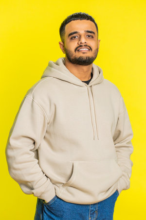 Cheerful lovely happy young man smiling friendly glad expression looking at camera dreaming resting relaxation feel satisfied good news. Guy isolated on yellow studio backgroundの写真素材