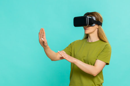 Middle-aged woman wears VR headset and carefully looks around, exploring digital environment with...
