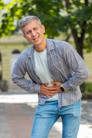 Caucasian man traveler feeling sudden strong abdominal stomach ache, gastritis problem. Upset...