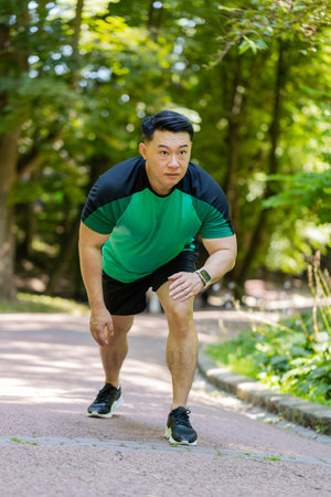 Athletic sport motivated runner guy training, preparing to run race marathon. Workout cardio in...