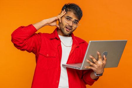 Displeased man use laptop notebook typing browsing working, loses becoming surprised by lottery bad...