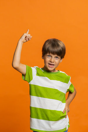 Eureka. Inspired young preteen child boy kid pointing finger up with open mouth, having good idea,...
