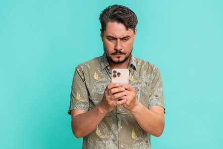 Middle-aged man anxiously types fast on smartphone, breathing deeply while focused on composing...