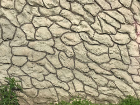 The fence of the private house is made of concrete slabs with a picture of vintage masonry.の写真素材