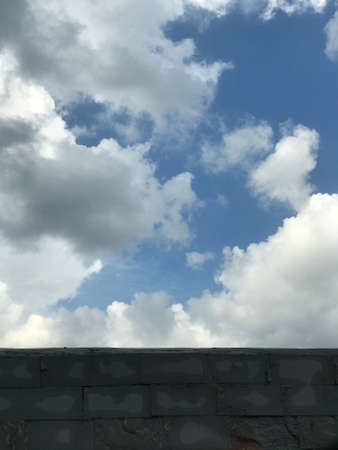 background clouds on a brick wall in clear skies after rain.