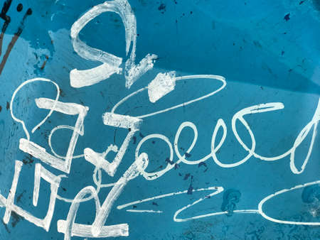 background texture graffiti on the blue table wet from the rain.の写真素材