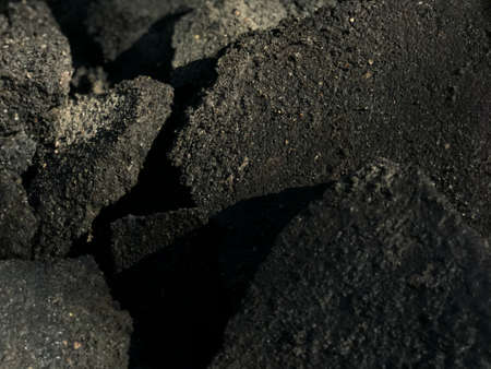 dark background pieces of asphalt old road in a heap.の写真素材