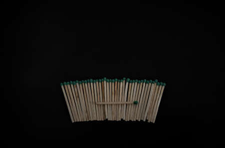 matches lined up in a row on a black background.の写真素材