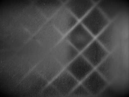 background texture is a white-colored window in a white building with a grille in the form of squares inside.の写真素材