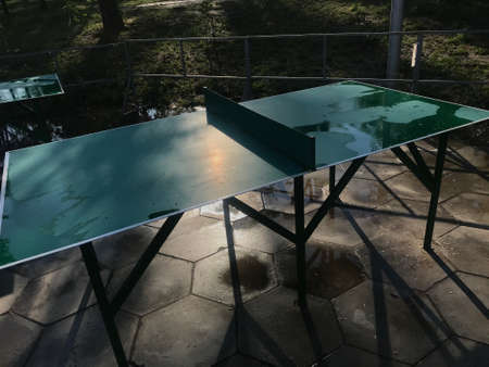table tennis in a park near the beach by the river in a dark way in the evening.の写真素材