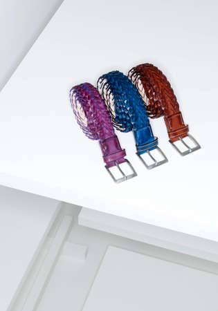 Colorful men's belts, group, isolated on a white background. Bunch of men's belts, group of leather belts for man, isolated. View of different leather belts with buckles.の写真素材