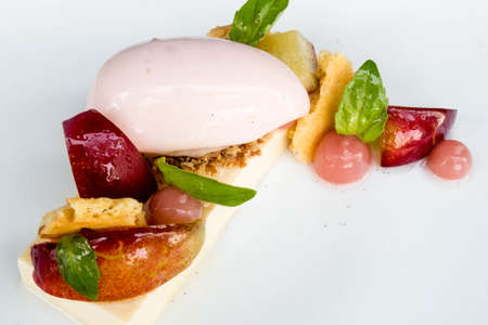 Dessert Poached peach, sorbet, close up. Peaches Poached in Sauternes with Creme Chantilly.の写真素材