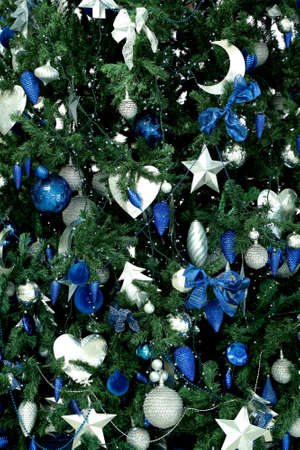 Festive Decorations, Christmas Tree decorated, Winter holidays ornaments, close up. Close up of Christmas tree decorated with gold small balls. New year background.の写真素材