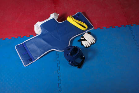 Taekwondo competition gear yellow belt on blue tatamiの写真素材