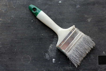 Flat lay used paintbrush with gray paintの写真素材