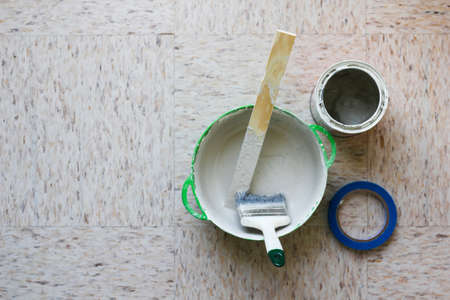 Flat lay set of wall painting elements paint bucket, paintbrush and blue masking tapeの写真素材