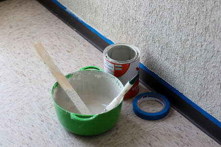 Set of wall painting elements, paint bucket, paintbrush and blue masking tapeの写真素材